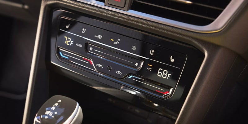 Car interior with a modern climate control panel displaying 72F on the left and 68F on the right.